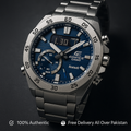 Edifice Casio watch with blue dial and silver metal strap on a dark background